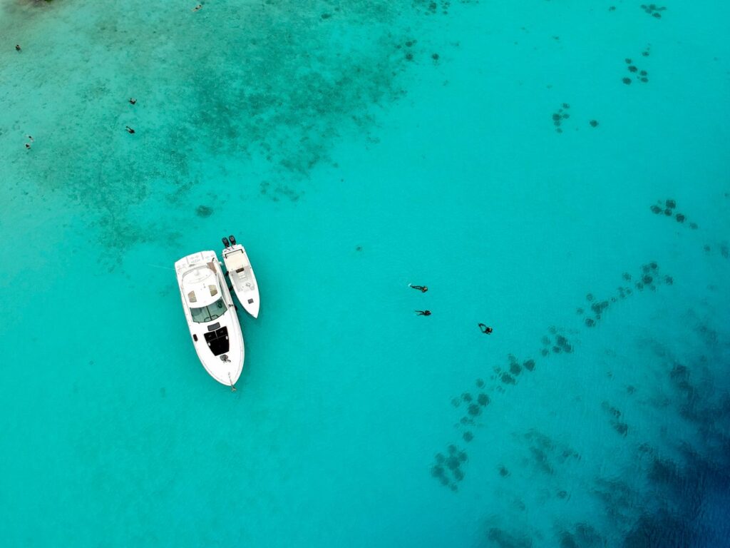 yacht anchored in the water with snorkelers in the water