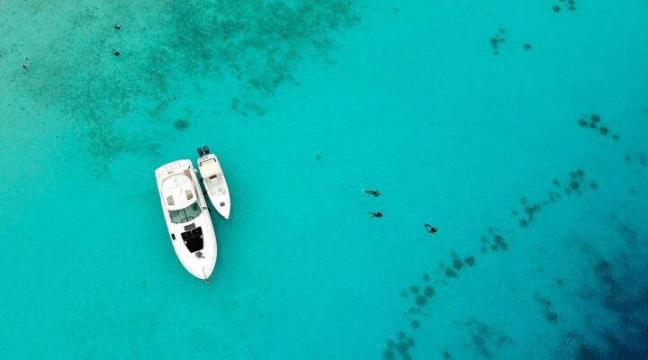 yacht anchored in the water with snorkelers in the water